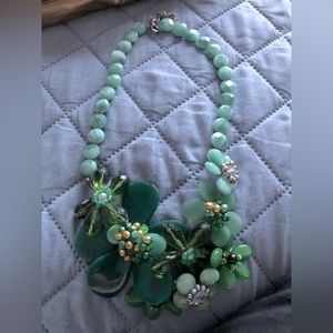 Lucious greens in this handmade floral necklace.
